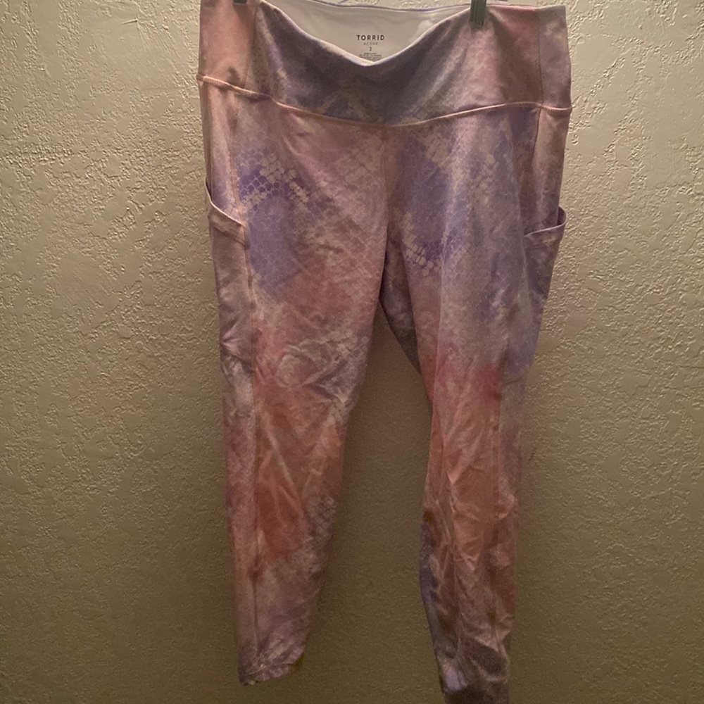 Torrid pink and lavender snake skin workout pants.